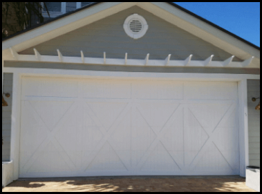 White specialty garage door for double garage, with barn door-style X pattern.